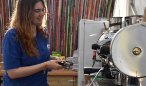 A Basecamp employee preparing a fresh coffee