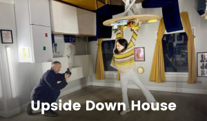 An optical illusion is created in the Upside Down House in Bristol. Kitchen fixings and furniture are suspended from the ceiling, and a girl pretends to do a handstand on the table while having her photo taken